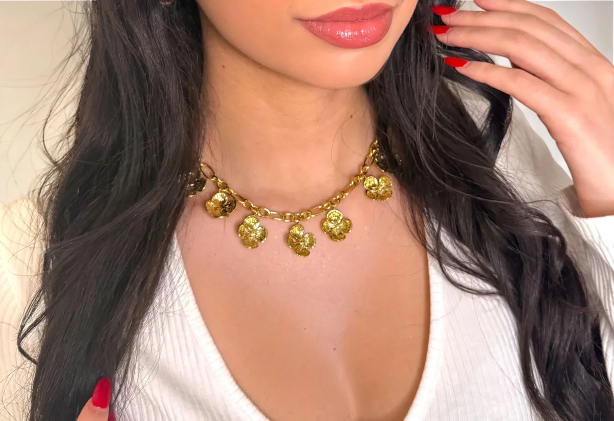 a woman wearing a gold necklace
