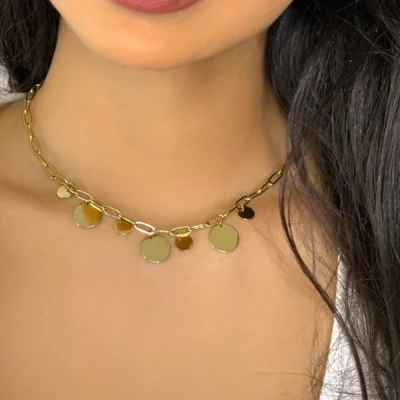 a woman wearing a gold necklace