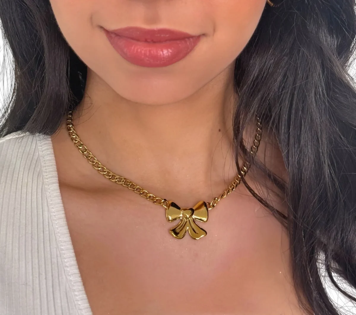 a woman wearing a gold necklace