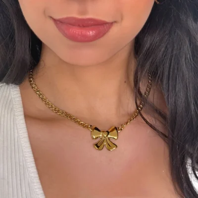 a woman wearing a gold necklace