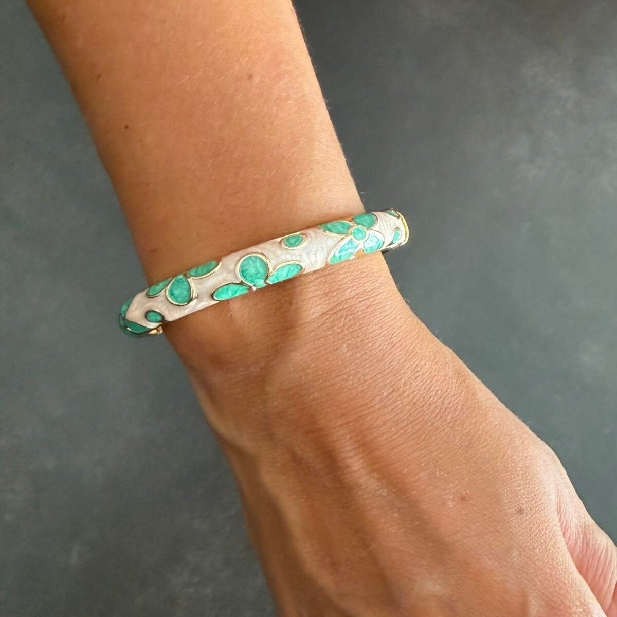 Bracelet Jonc Émaillé Vert d'Eau Fleurs 3 Bracelet jonc émaillé vert d'eau au poignet, fleurs en émail et finition dorée