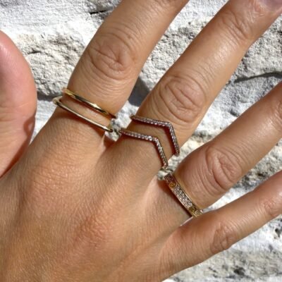 Bague chevron double V dorée portée au majeur