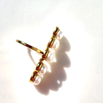 Ear cuff barrette perles dorée sur plateau blanc, anneau ouvert visible